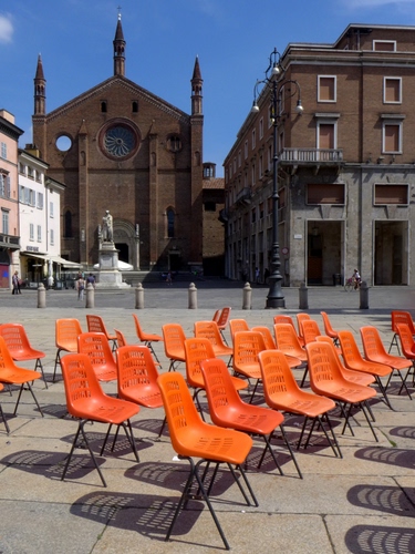 Immagine con chiesa, sedie, piazza, arancione, ombre, arancio, lampioni, monumento