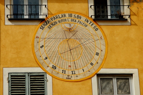 Immagine con meridiana, numeri, finestre, giallo, orologio, asta, ore, cerchio, scritta, muro