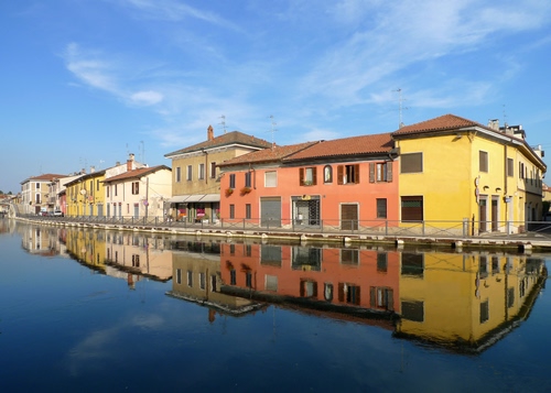 Immagine con case, acqua, cielo, riflessi, riflesso, fiume, colori, canale, nuvole, azzurro, finestre, giallo